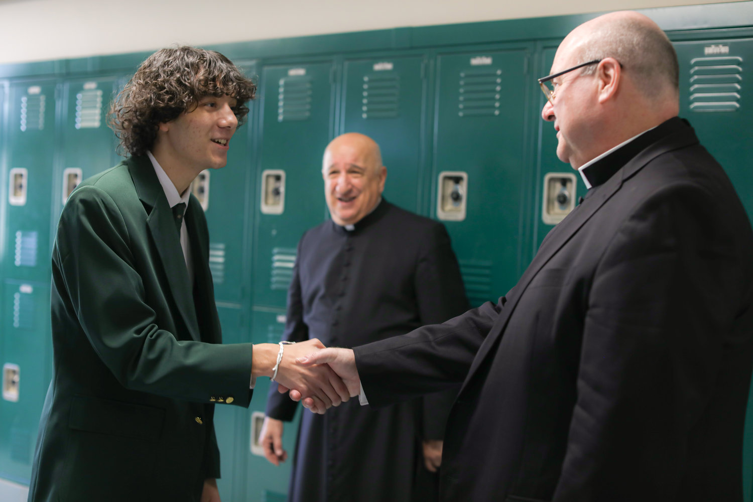 Coadjutor Bishop Richard G. Henning visits Bishop Hendricken High School on Friday, March 3. Pictured: During a tour of the school, Bishop Henning greets student Abel Perez ‘23.